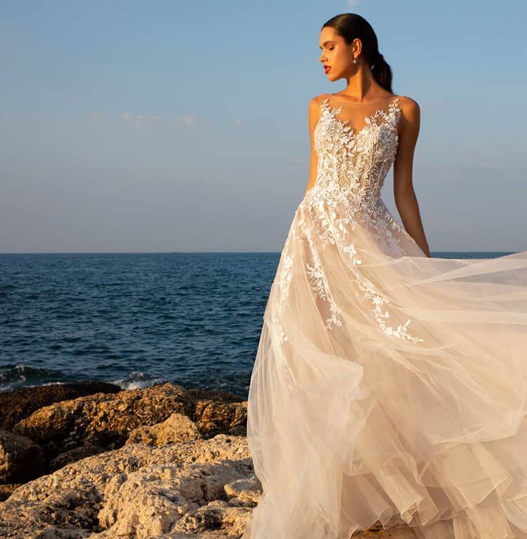 Model wearing a white wedding dress with floral details from Ana's Bridal in East Providence Rhode Island shown on mobile device